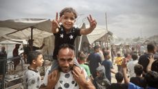 Palestinians celebrate news of a peace deal between representatives of Israel and Hamas