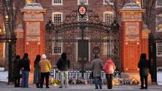 A memorial to the Brown University shooting victims is seen in front of the campus’ gates.