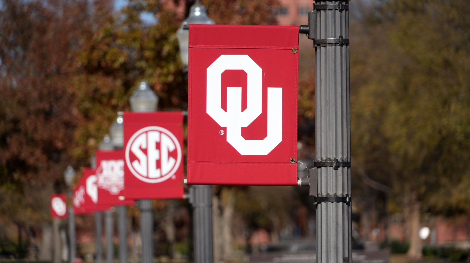 NORMAN, OKLAHOMA - DECEMBER 01: Banners with the Oklahoma Sooners and Southeastern Conference (SEC) logos on the campus of Oklahoma University on December 01, 2024 in Norman, Oklahoma. (Photo by Kirby Lee/Getty Images)